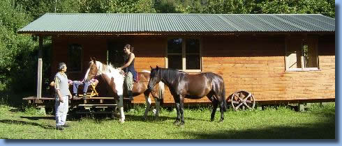 2 horses and riders in front of Cabin at Antilco the horse riding ranch in Chile 